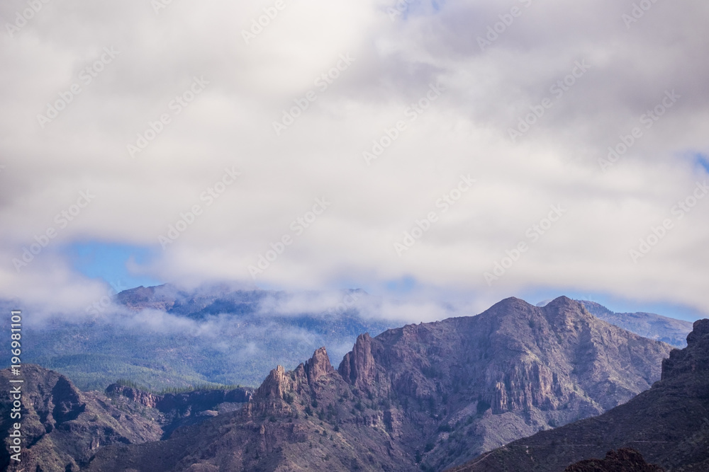 mountain view with clouds in tenerife. dry rocks