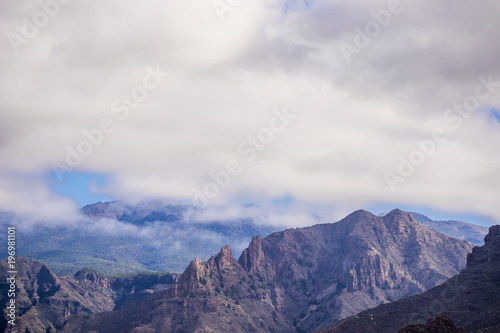Fototapeta Naklejka Na Ścianę i Meble -  mountain view with clouds in tenerife. dry rocks