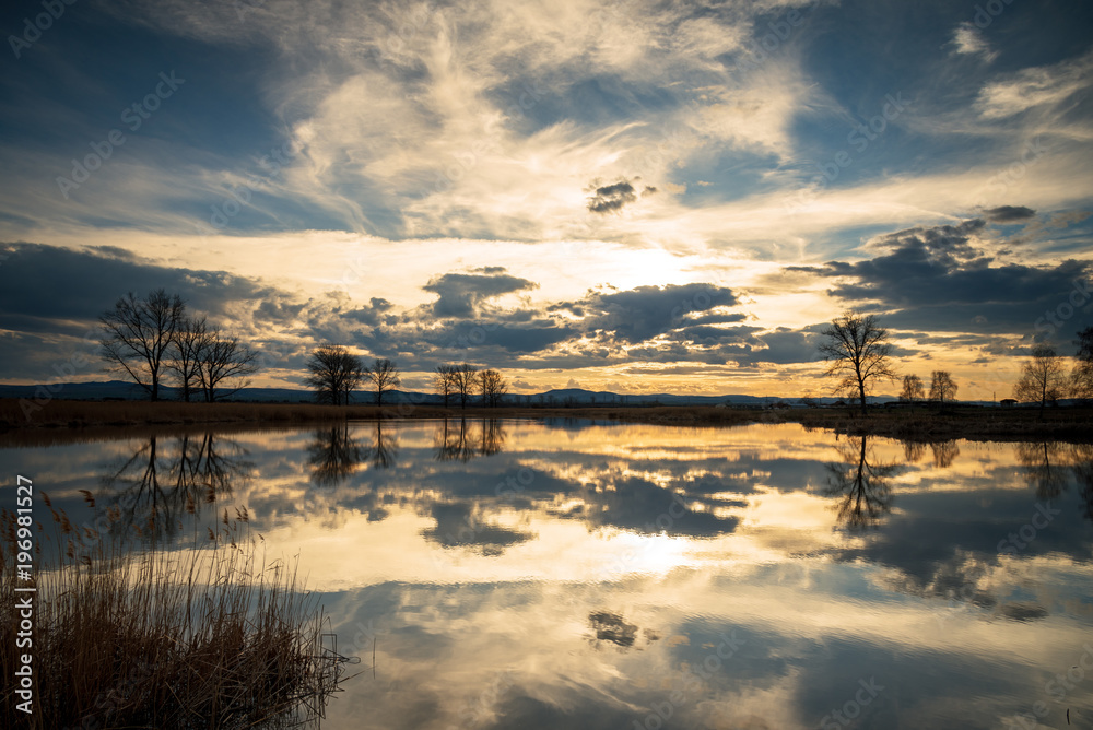 Sunset over lake and beautiful clouds.