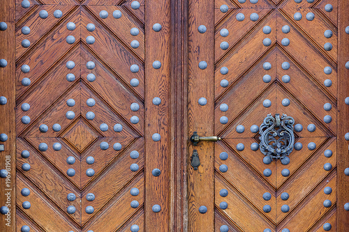 Wooden door with handle ring and iron rivets