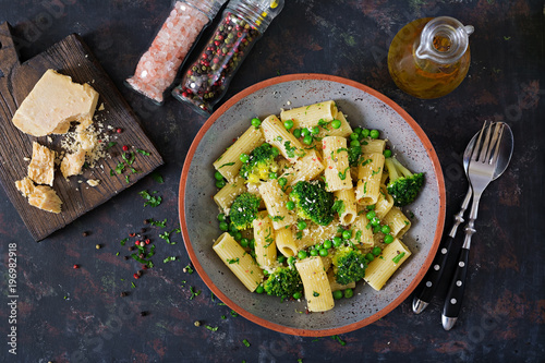 Pasta rigatoni with broccoli and green peas. Vegan menu. Dietary food. Flat lay. Top view. photo