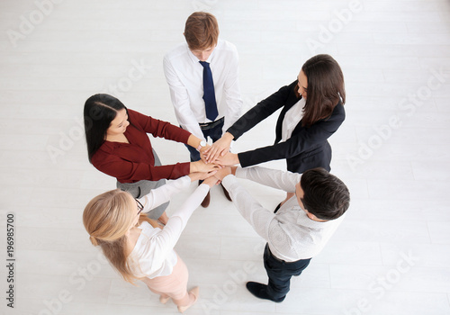 People putting hands togeth...
