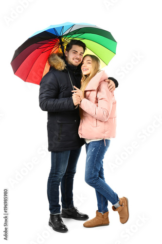 Young romantic couple with colorful umbrella on white background