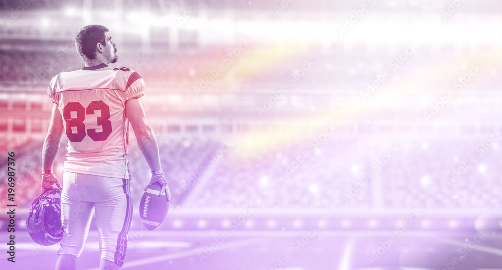 American Football Player isolated on big modern stadium field American Football Player isolated on big modern stadium field