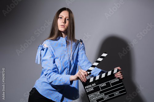 Young beautiful brown-haired woman with a movie cracker photo