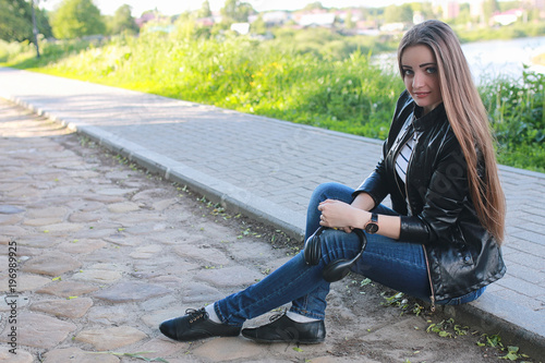 Young girl on a walk. Girl in a leather jacket on the street. Be © alexkich