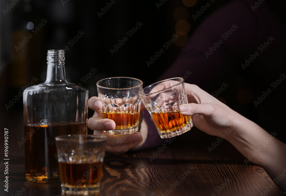 Couple drinking in bar, closeup. Alcoholism problem Couple drinking in bar, closeup. Alcoholism problem