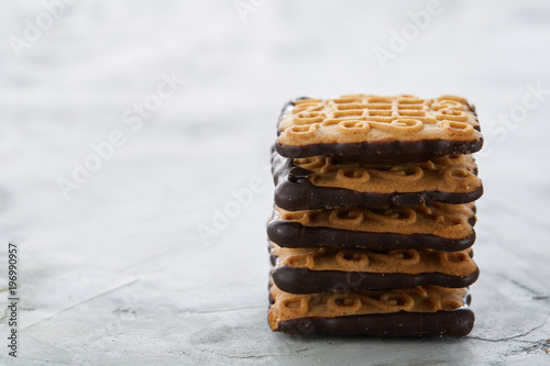 Square biscuits arranged in pattern on light textured background, close-up, shallow depth of field, selective focus.