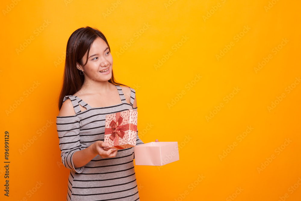 Young Asian woman open a gift box. Young Asian woman open a gift box.