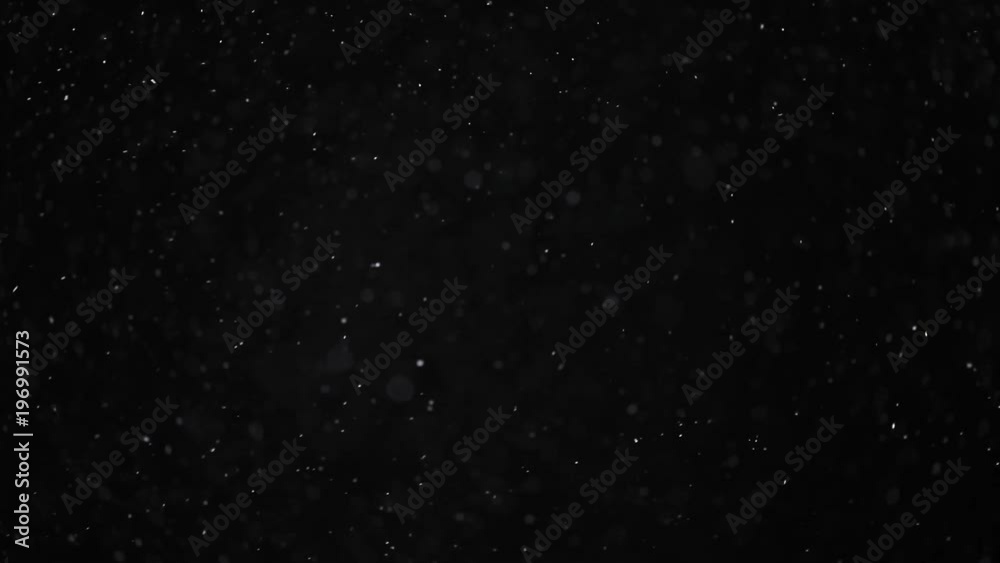 Natural organic dust particles on black background. Glittering Particles With Bokeh. Slow motion. Natural organic dust particles on black background. Glittering Particles With Bokeh. Slow motion.