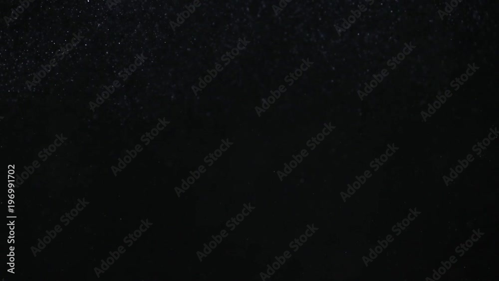 Natural organic dust particles on black background. Glittering Particles With Bokeh. Natural organic dust particles on black background. Glittering Particles With Bokeh.