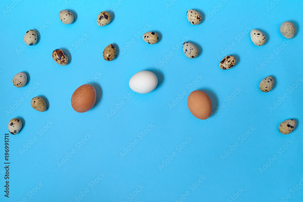 Border of white, brown and quial eggs on blue background, copy space. Healthy food concept. Top view, flat lay. Easter eggs. Happy Easter concept Border of white, brown and quial eggs on blue background, copy space. Healthy food concept. Top view, flat lay. Easter eggs. Happy Easter concept