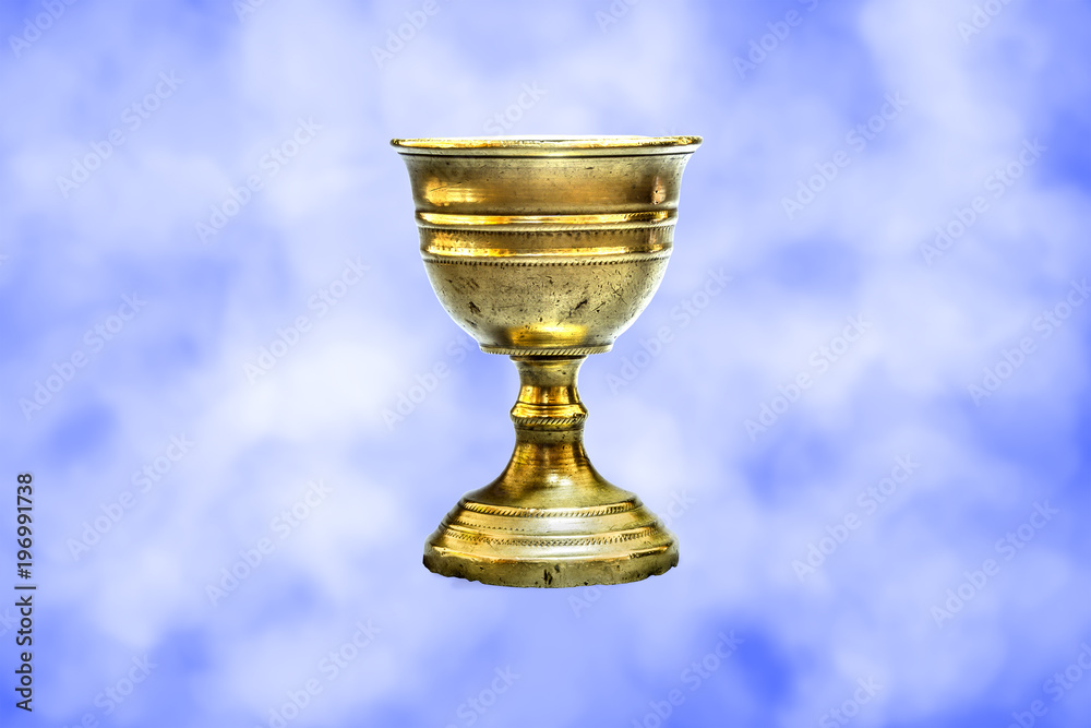 Old chalice on clouds background Old chalice on clouds background