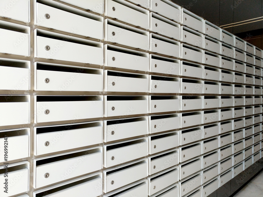mail boxes or lockers for many people in the same living area, no name or tag, empty box with key holes