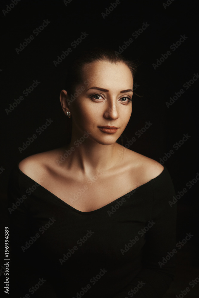 Beautiful model is deeply emotionally posing in a dark studio Beautiful model is deeply emotionally posing in a dark studio