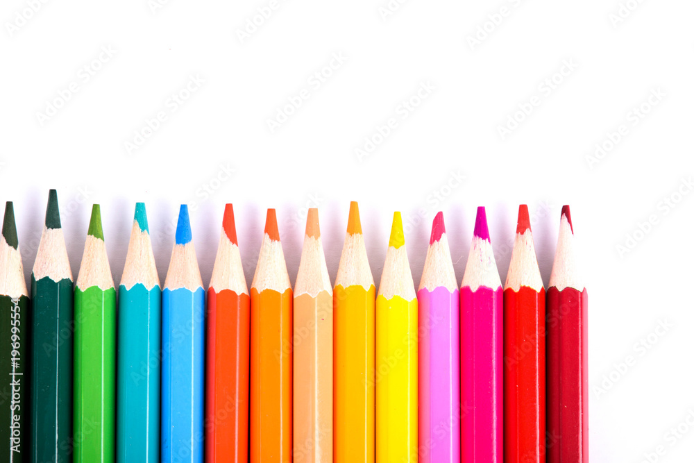 Red pencil standing out from crowd of plenty identical black fellows on white table. Leadership, uniqueness, independence,  initiative, strategy, dissent, think different, business success concept
