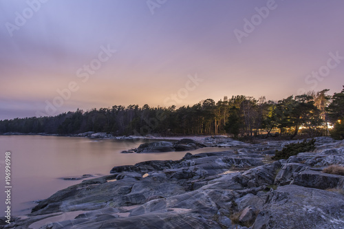 Klippor utanför Björnö i Stockholms skärgård i månsken på natten photo