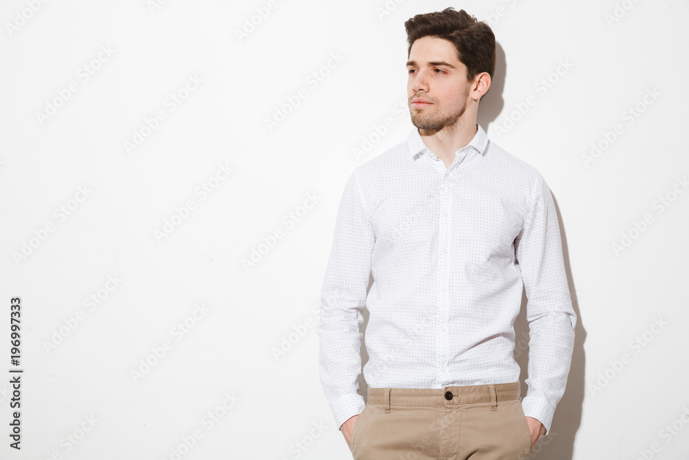 Portrait of a serious young man dressed in shirt Portrait of a serious young man dressed in shirt