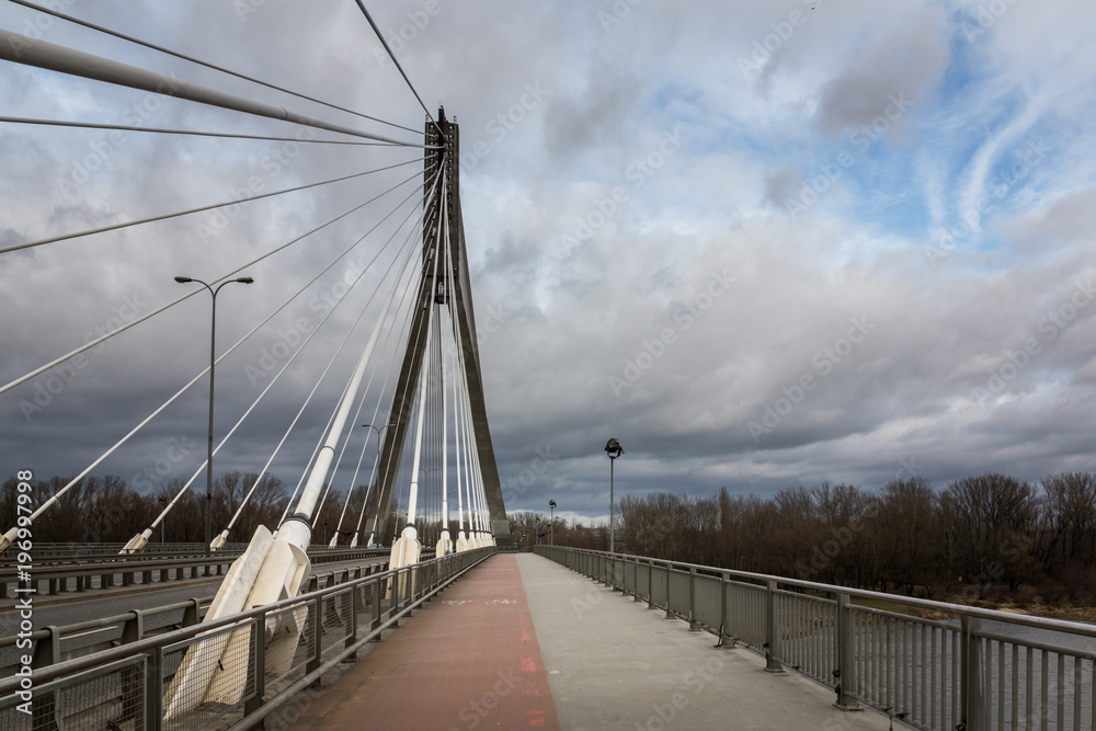 Swietokrzyski bridge over the Vistula river at cloudy day in Warsaw, Poland