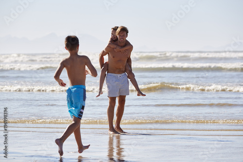 Father With Children Having Fun On Summer Beach Vacation
