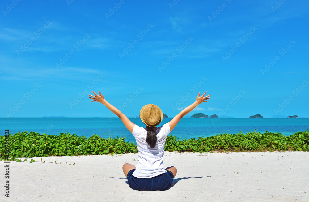 Happy woman traveler relaxing on a perfect beach in Samui island, Thailand Happy woman traveler relaxing on a perfect beach in Samui island, Thailand