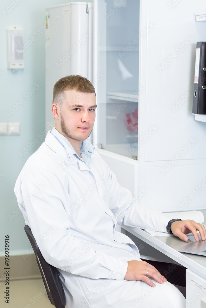 Research or genetics scientist using laptop in medical office or laboratory. Research or genetics scientist using laptop in medical office or laboratory.