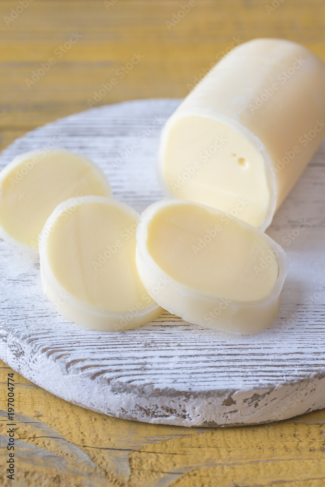 Sliced Formaggio on the wooden board Sliced Formaggio on the wooden board
