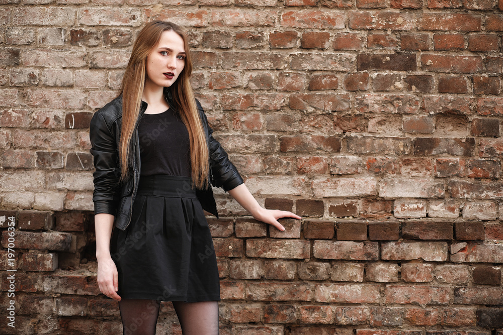 Young beautiful girl in a hat and with a dark make-up outside. G