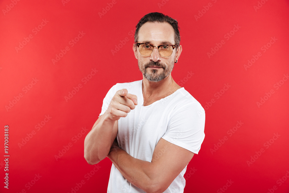 Concentrated man in colorful sunglasses pointing. Concentrated man in colorful sunglasses pointing.