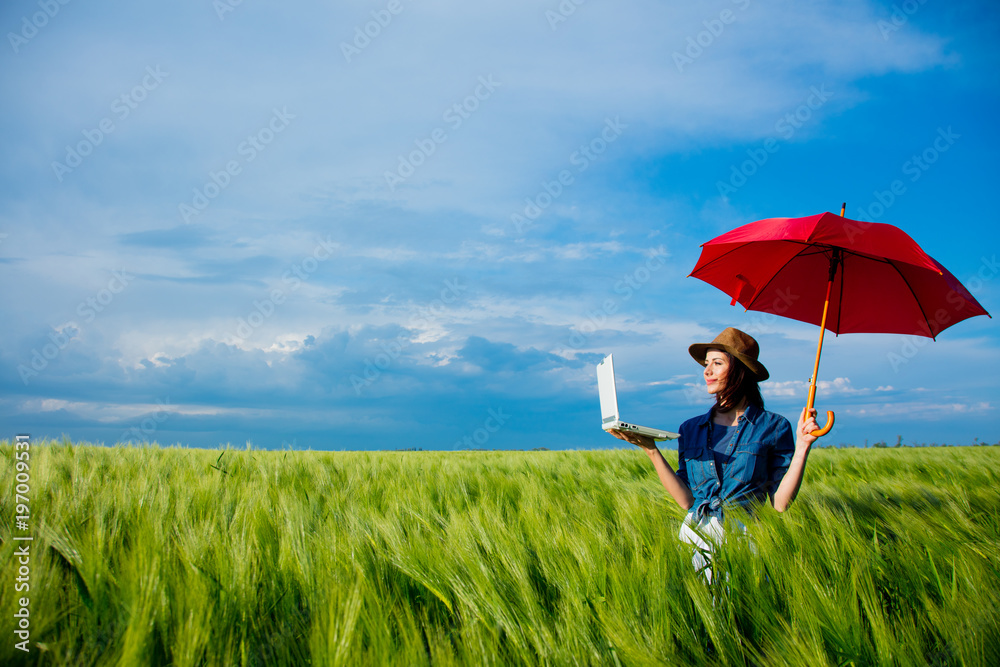 Beautfiul redhead girl with laptop and umbrella Beautfiul redhead girl with laptop and umbrella