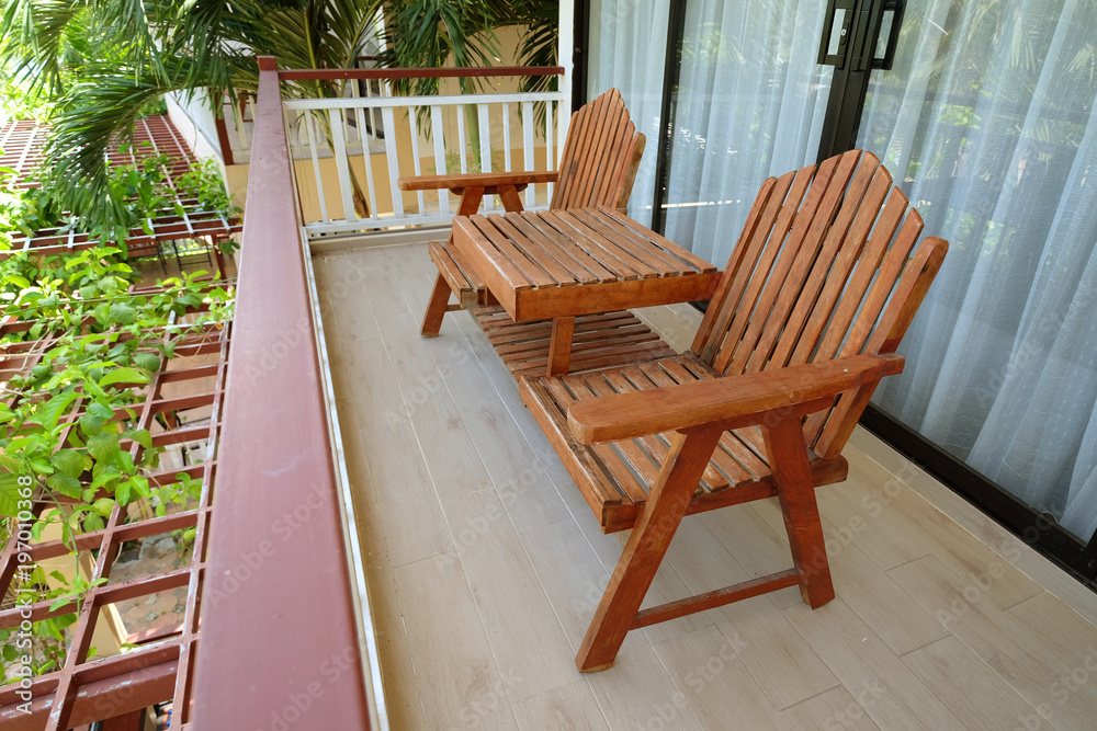 Couple of wooden chairs at balcony terrace on second floor outside the room - obrazy, fototapety, plakaty 