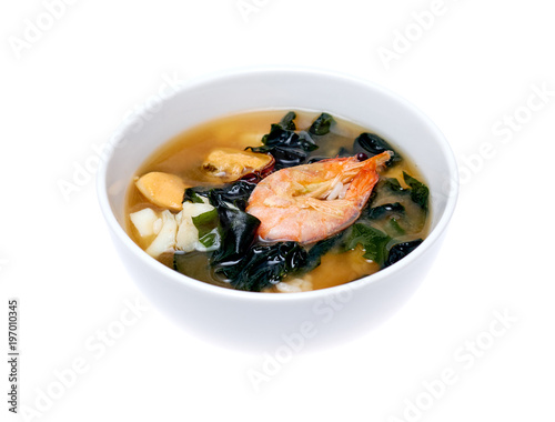 Bowl of seafood soup over white background