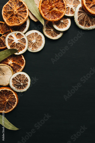 Frame of dry fruits slices on black background