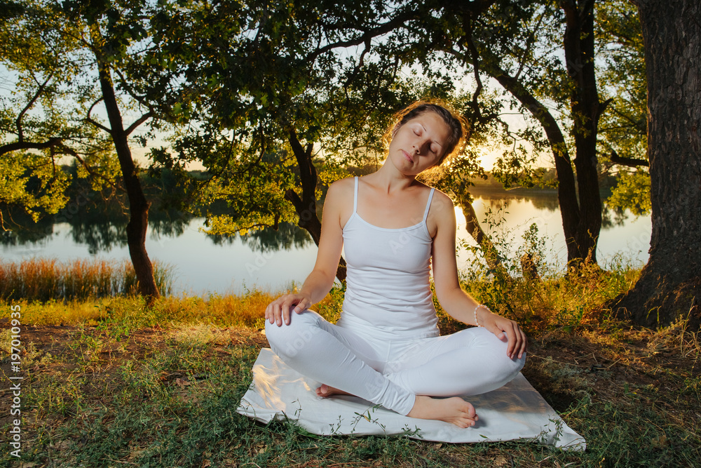 Φωτογραφία yogin girl relaxing in the forest in meditation in the rays of the setting sun