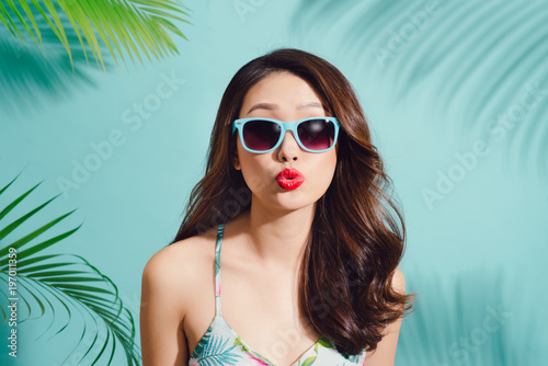 Summer fashion portrait of beautiful elegant asian woman posing in summer outfit