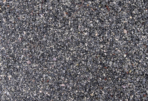 Fine gravel, small irregular gray stones on horizontal outdoor path, for use as background texture
