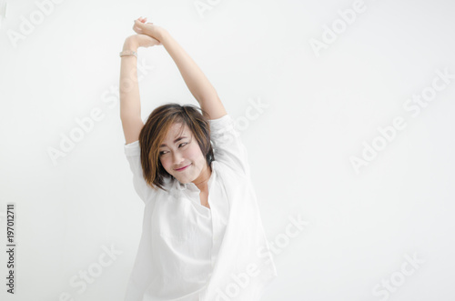 Beautiful Asian woman feeling lazy with white room.