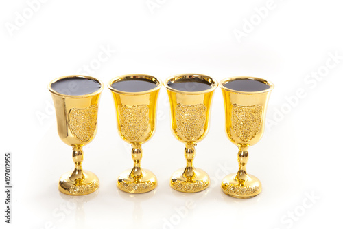 passover elements on studio shite background,  four goblets of wine photo