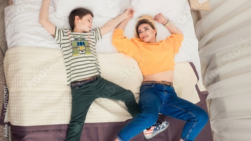 Mother with son on bed, mother and son having fun photo