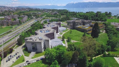 Lausanne University campus aerial shot. Iconic futuristic building with the city and the lake in the backtround