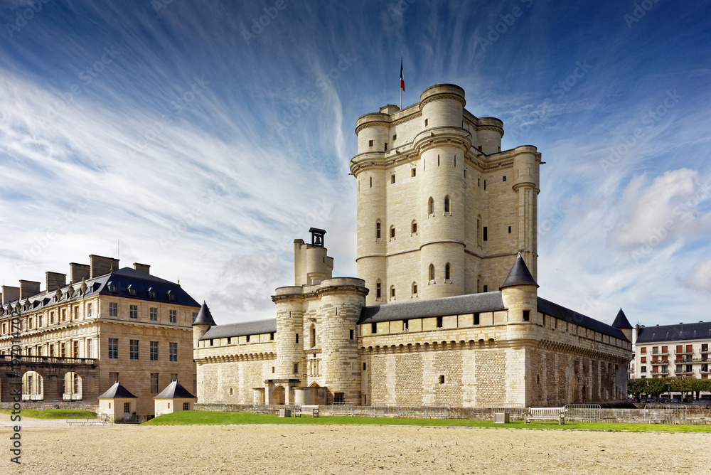 Chateau de Vincennes in Paris. France castle with French national flag under the sunny blue sky. - obrazy, fototapety, plakaty 