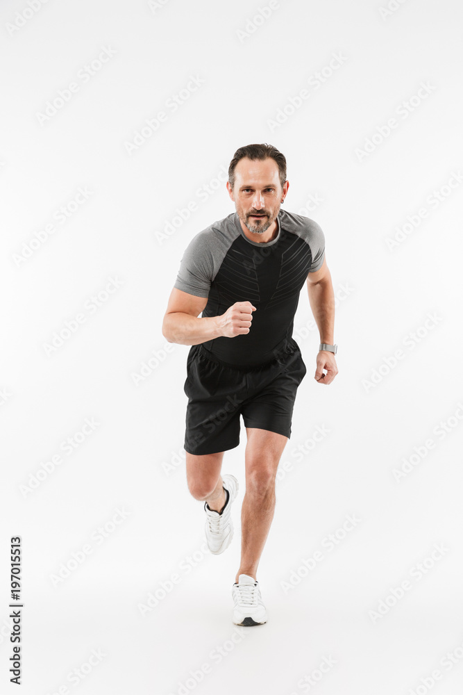 Handsome serious mature sportsman running isolated