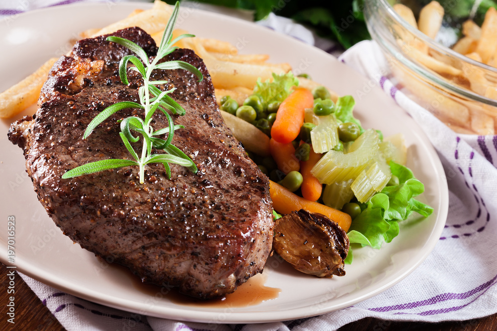 Beef steak served with baked potatoes