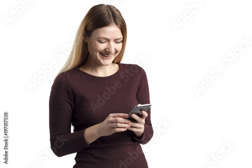 Surprised young female blogger chatting with best friends in social network on mobile phone while received shocking good news using wifi zone isolated on white background