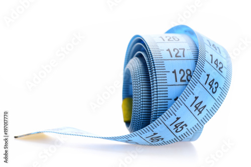 Blue rolled measuring tape isolated on white background.