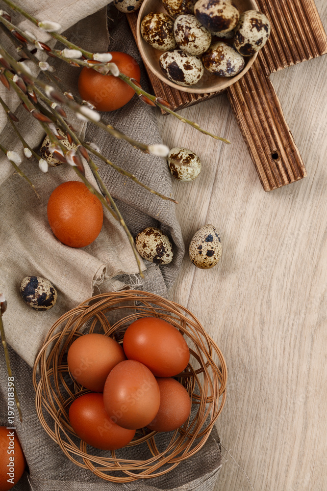 quail and chicken eggs with willow branches wyth textile. Springtime. Top view. Copyspace. Happy easter