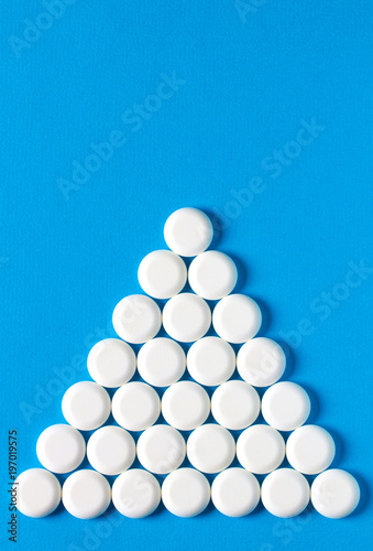 pills pyramid perfectionism blue medical background 