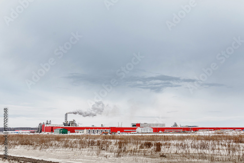 Chemical plant with smoking pipe at winter photo