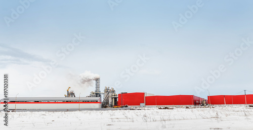 Chemical plant with smoking pipe at winter photo