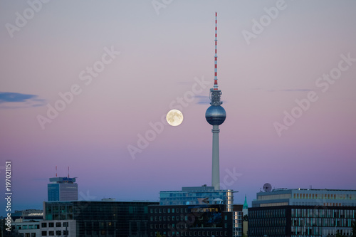 Photography Berlin's TV tower with a full moon at sunset